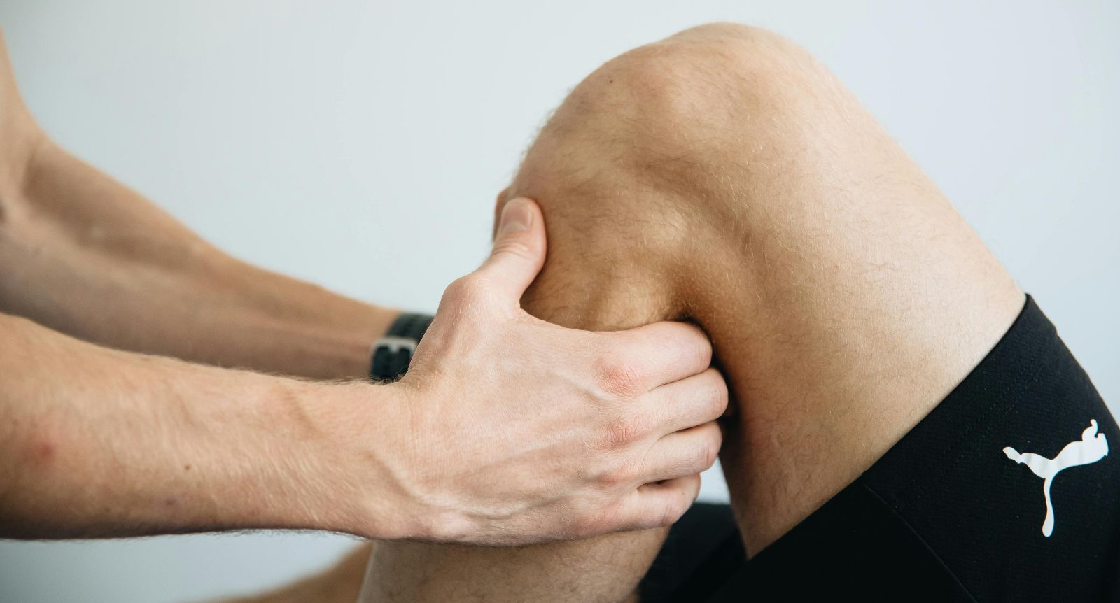 Physiotherapist assessing a knee