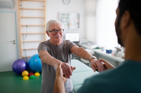 Physiotherapist assessing a patient's shoulder range of movement